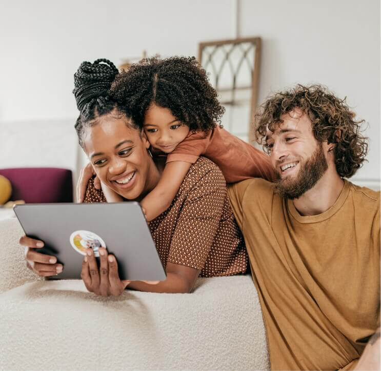 Family of three looking at a tablet